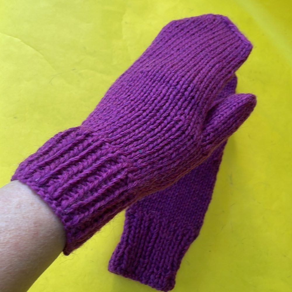 Purple hand knitted wool mittens